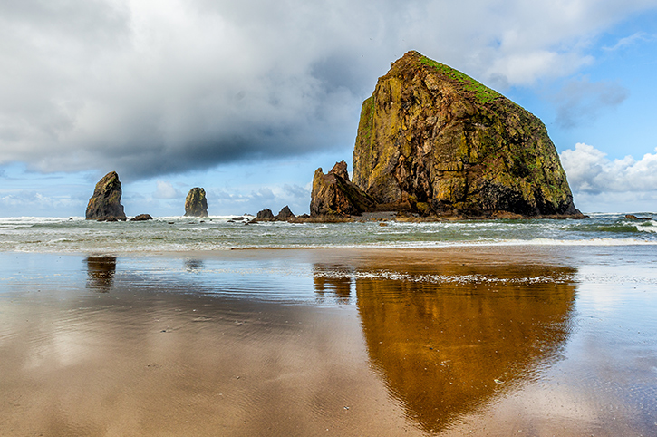 Reflections of Haystack Rock, Cannon Beach, Oregon, America