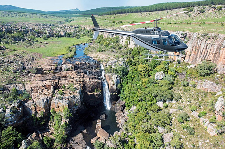 Helicopter above waterfall, Lion Sands, South Africa