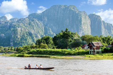Boat cruising up the Nam Song River, Vang Vieng, Laos