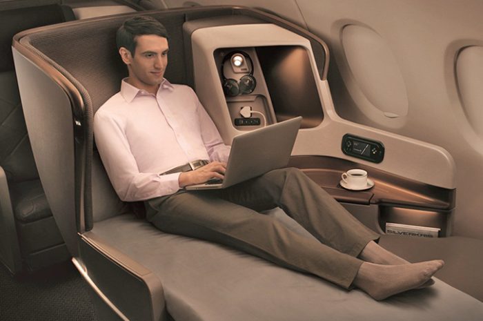 Man relaxing in business class, Singapore Airlines